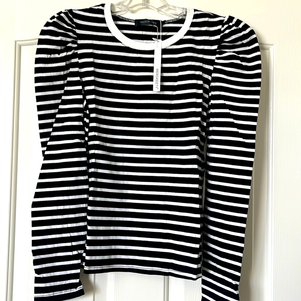 Black/white tee shirt with white trim and puff sleeves.